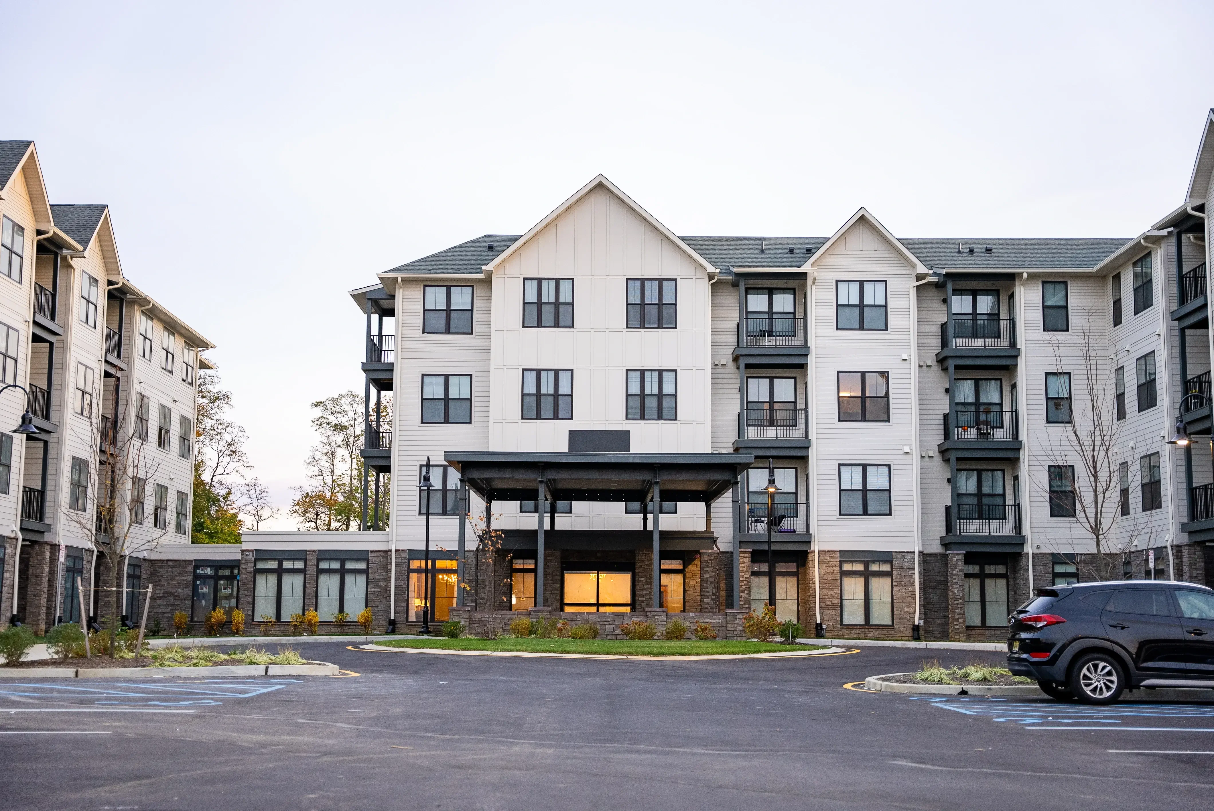 This image showcases a completed multi-family residential project, framed by an orange graphic with the text Completed Projects. It highlights the finished structure's design and aesthetic.