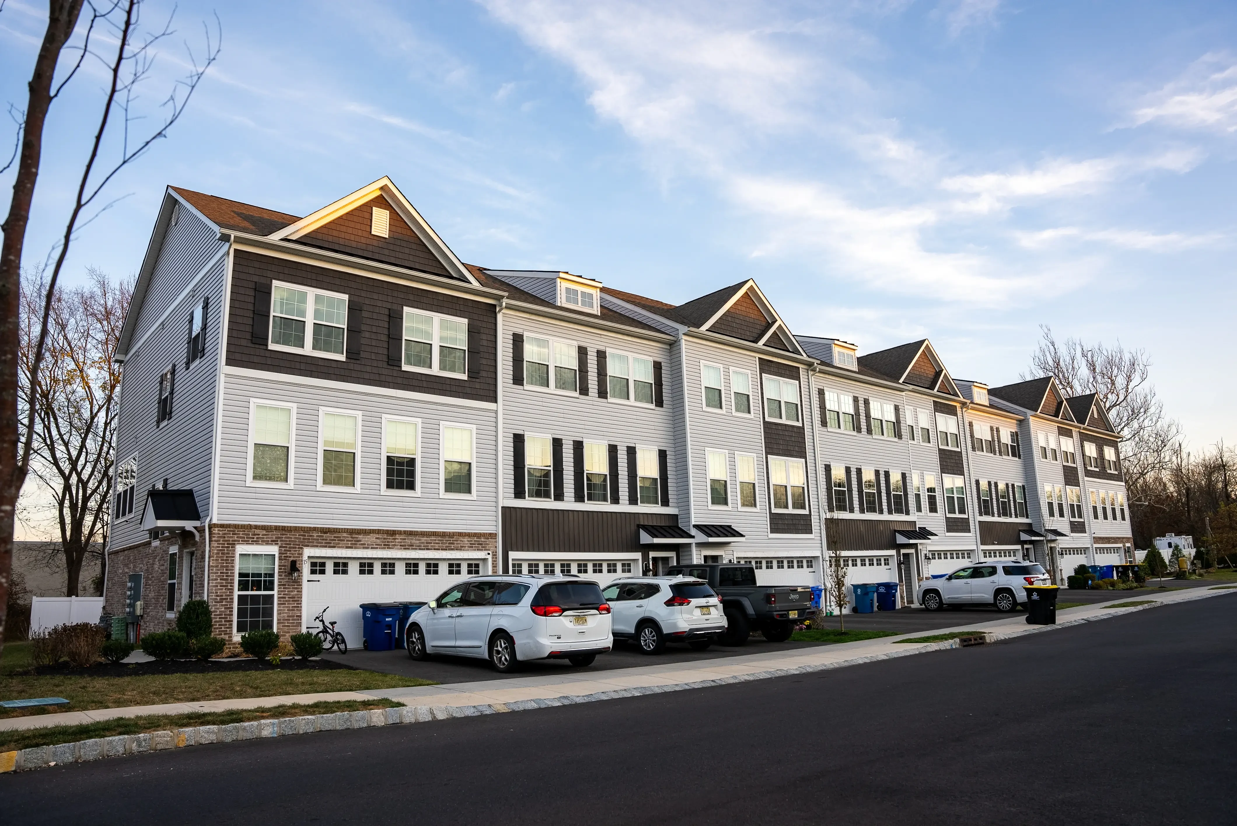 This image highlights a residential building featuring a combination of modern and traditional design elements. It showcases brick accents on the lower level, contrasting siding on upper levels, and clean windows for a polished appearance. The layout demonstrates a focus on functionality and aesthetic appeal, ideal for suburban living.
